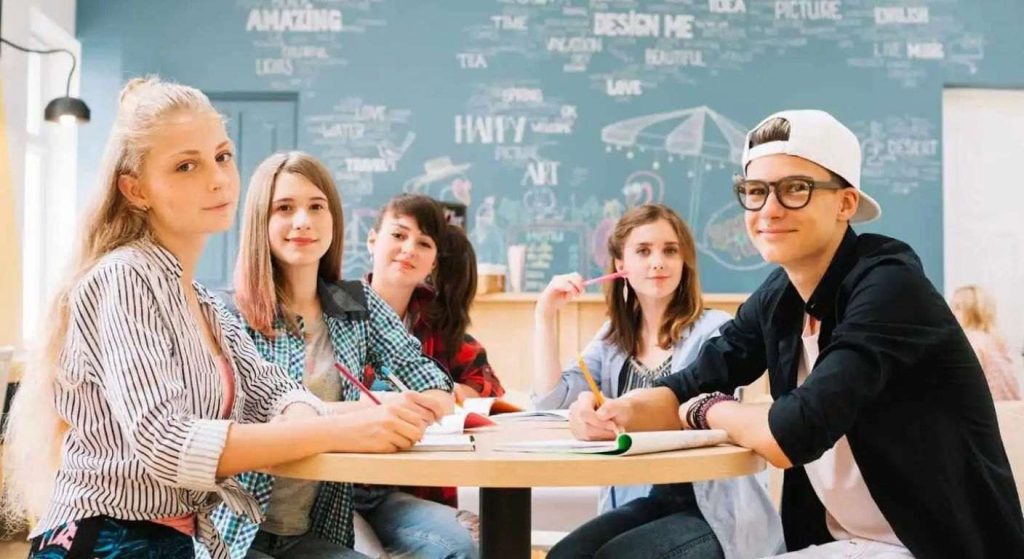 group-students-posing-table